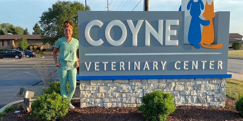 posing with the Coyne sign